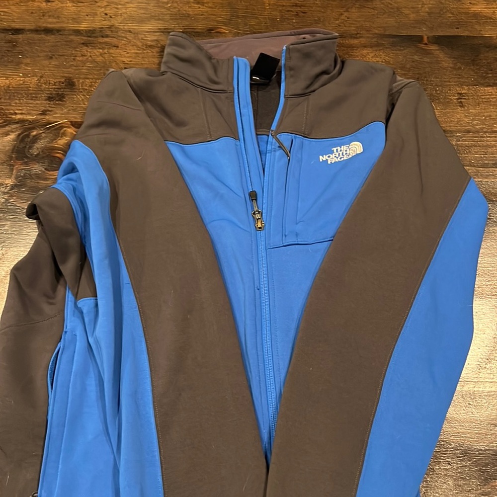 blue and grey north face zip up jacket